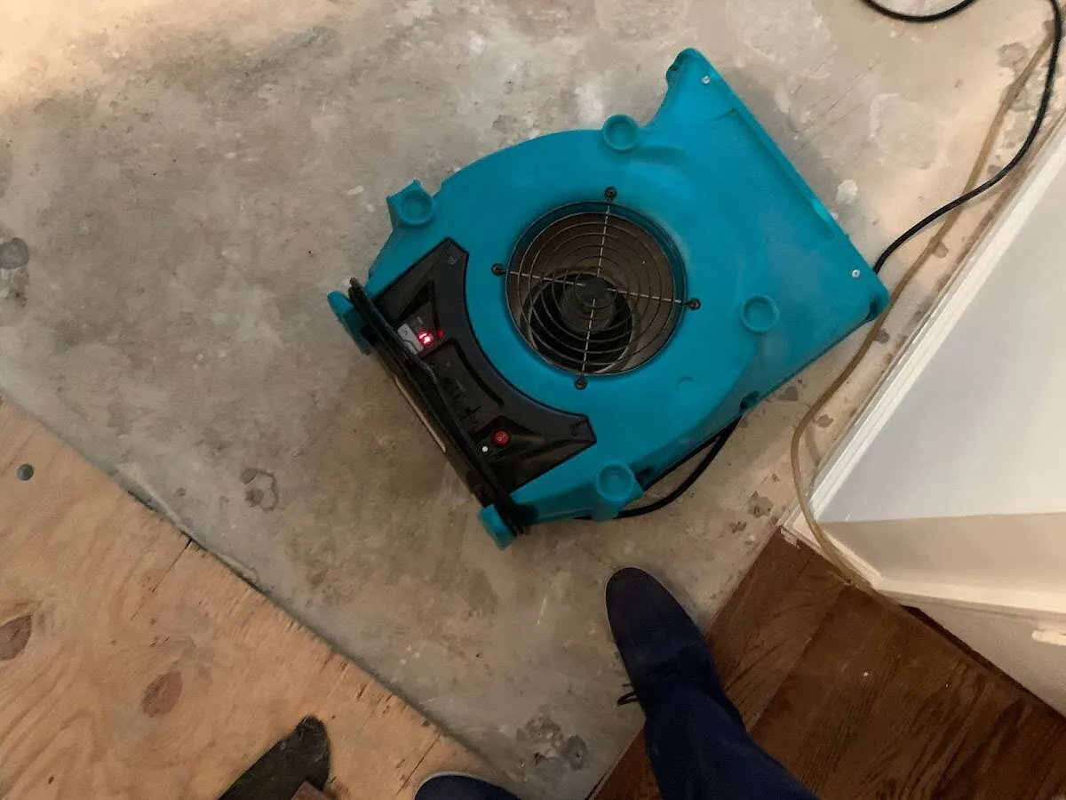 Air mover drying subfloor during Commercial Water Damage Restoration in Travilah
